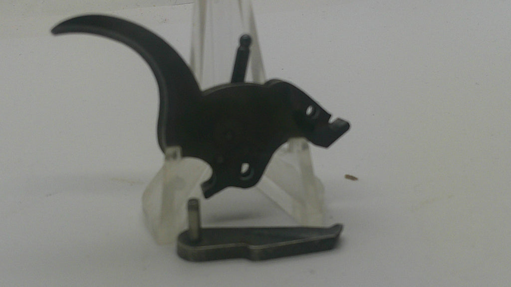 A black metal trigger lock or safety device displayed on a clear plastic stand against a plain light background.