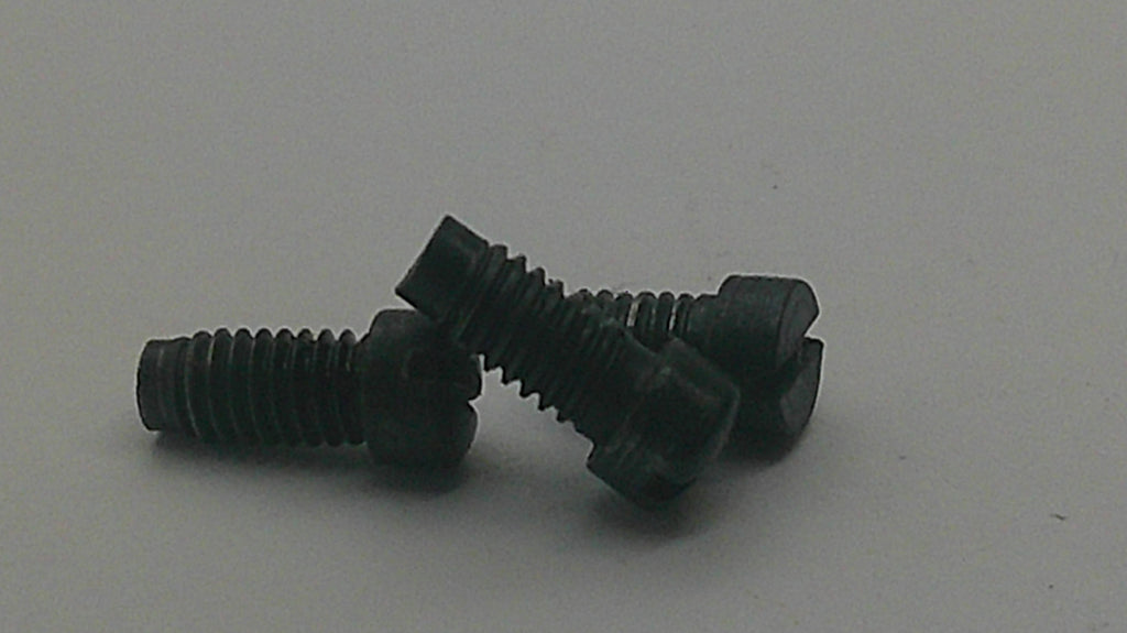 Three black metal flat-head hex screws with threaded shanks, arranged on a plain light gray background.