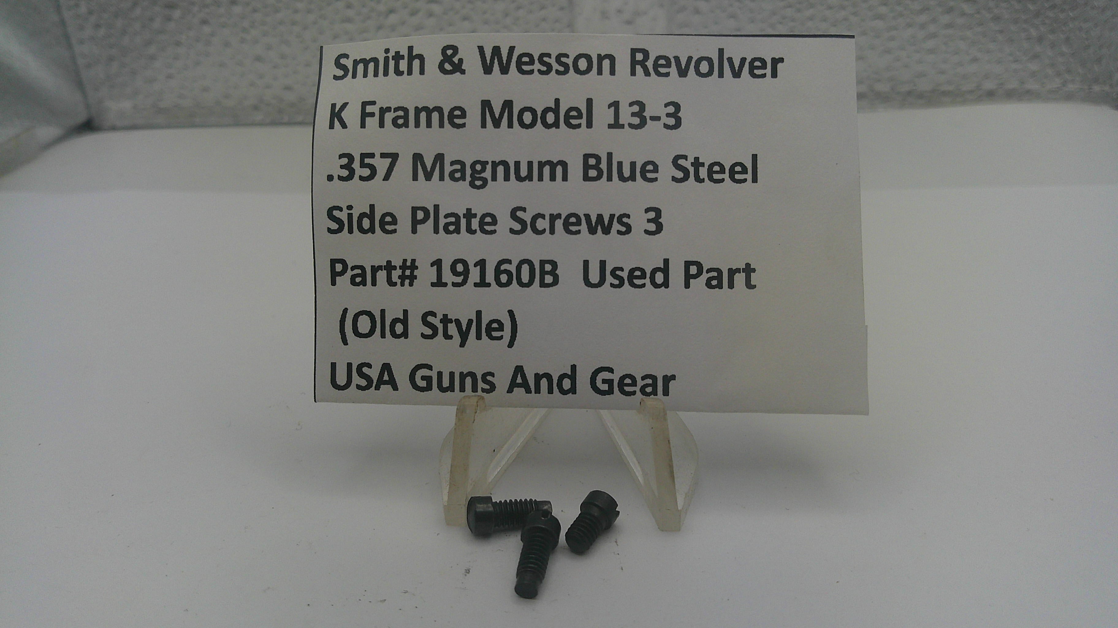 Three small black metal screws displayed below a white sign that reads 'Smith & Wesson Revolver K Frame Model 13-3 .357 Magnum Blue Steel Side Plate Screws 3 Part# 19160B Used Part (Old Style) USA Guns And Gear' on a white stand.