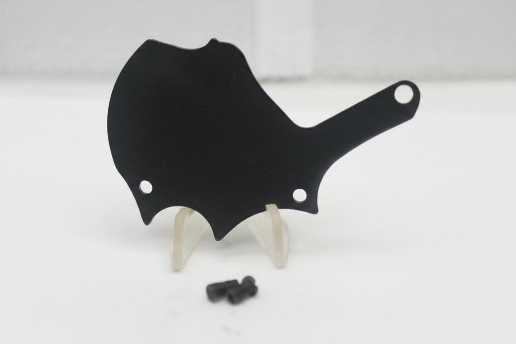 Black plastic component on a white surface