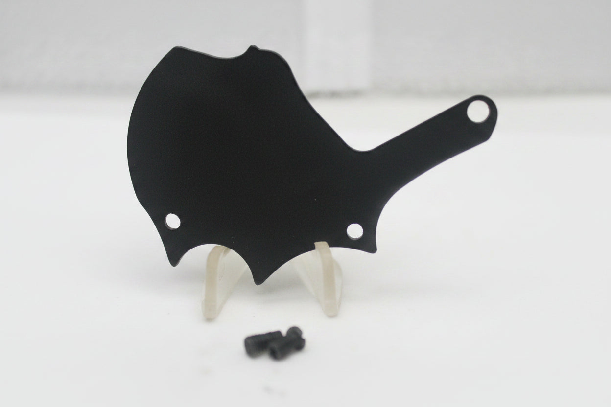 Black plastic component on a white surface