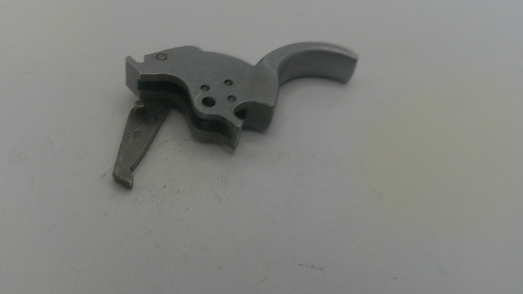 Metallic firearm part on a white background