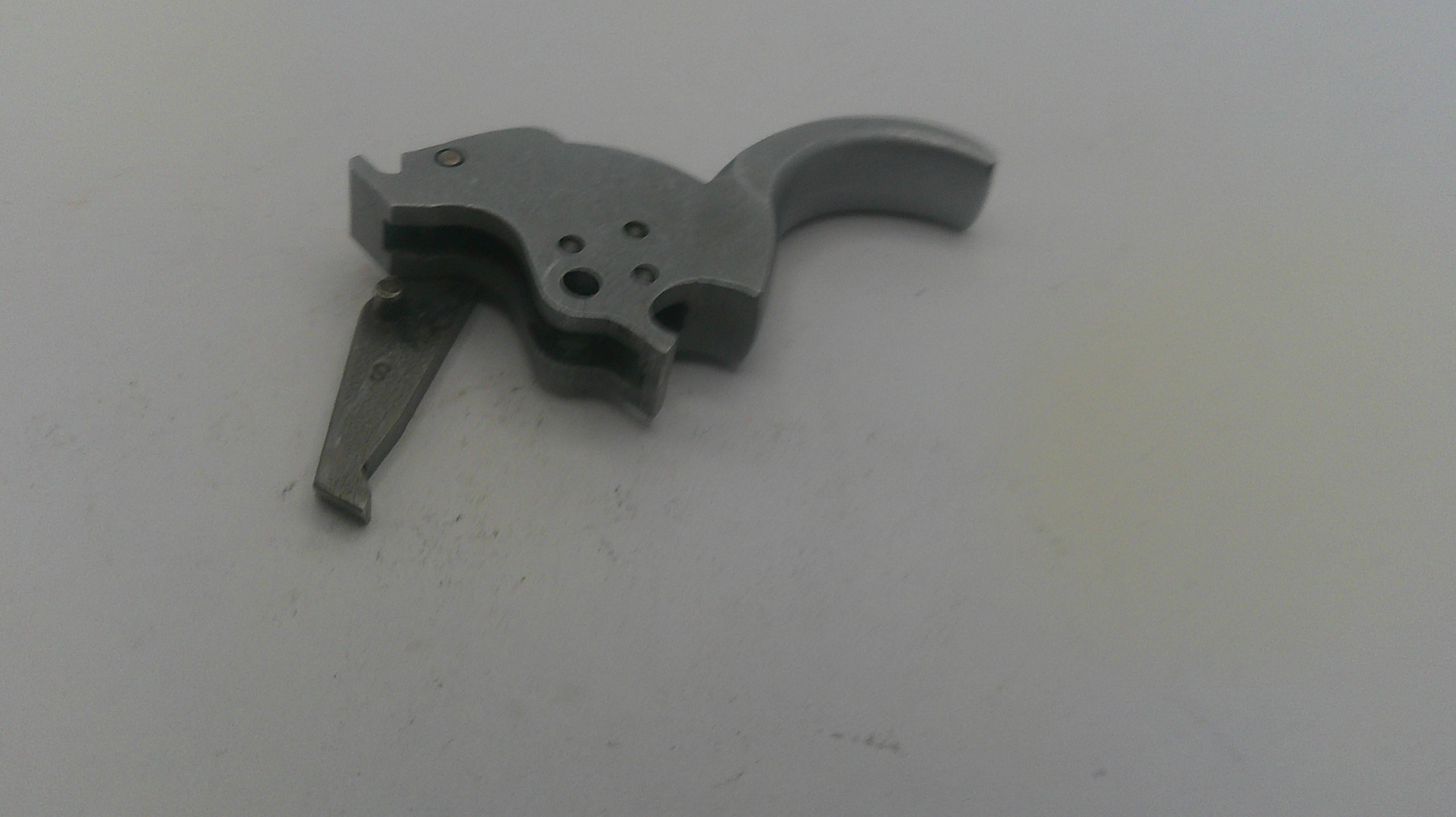 Metallic firearm part on a white background