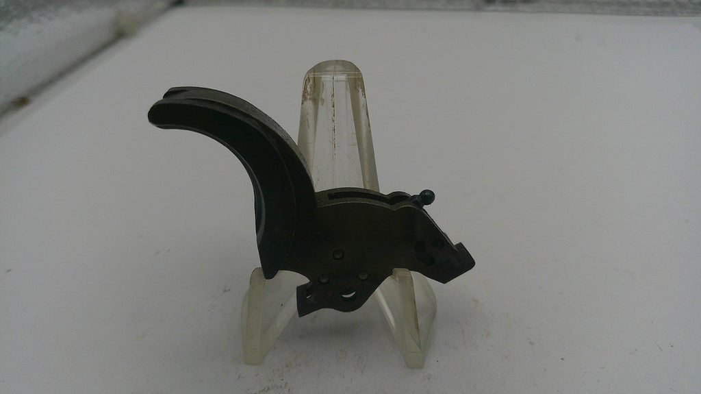 Black metal bracket on a clear stand against a white background