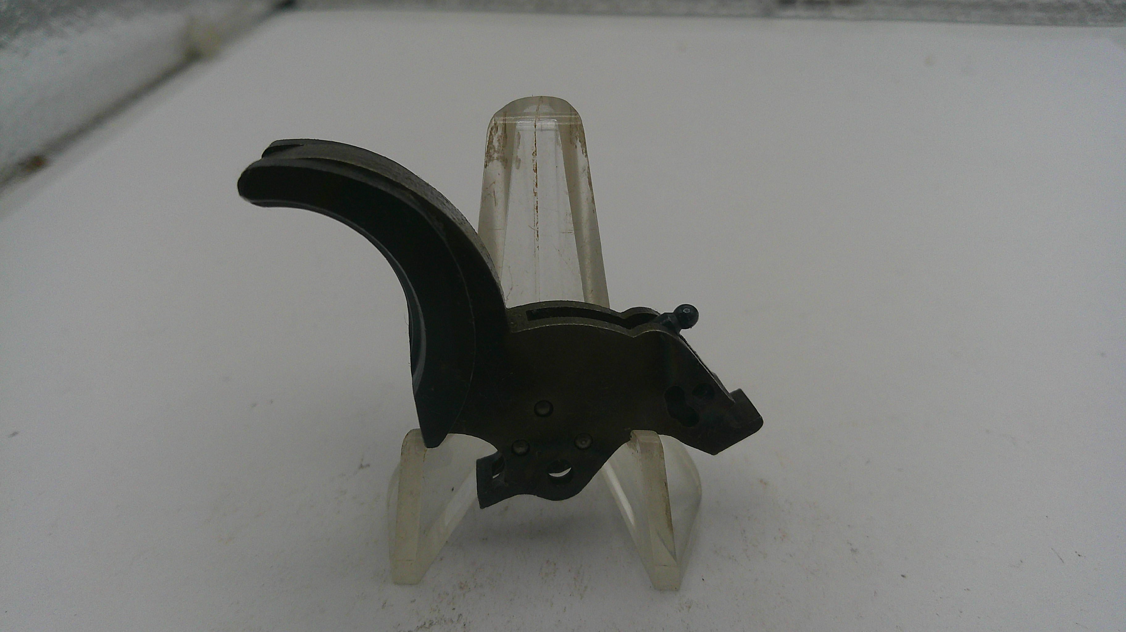 Black metal bracket on a clear stand against a white background