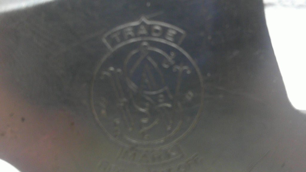 Close-up of a black surface with an embossed logo and text.