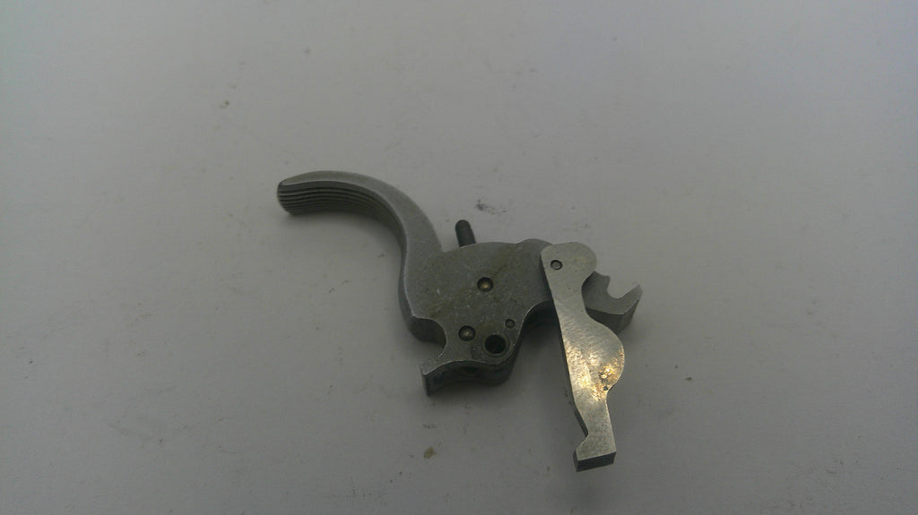 Metallic firearm part on a white background