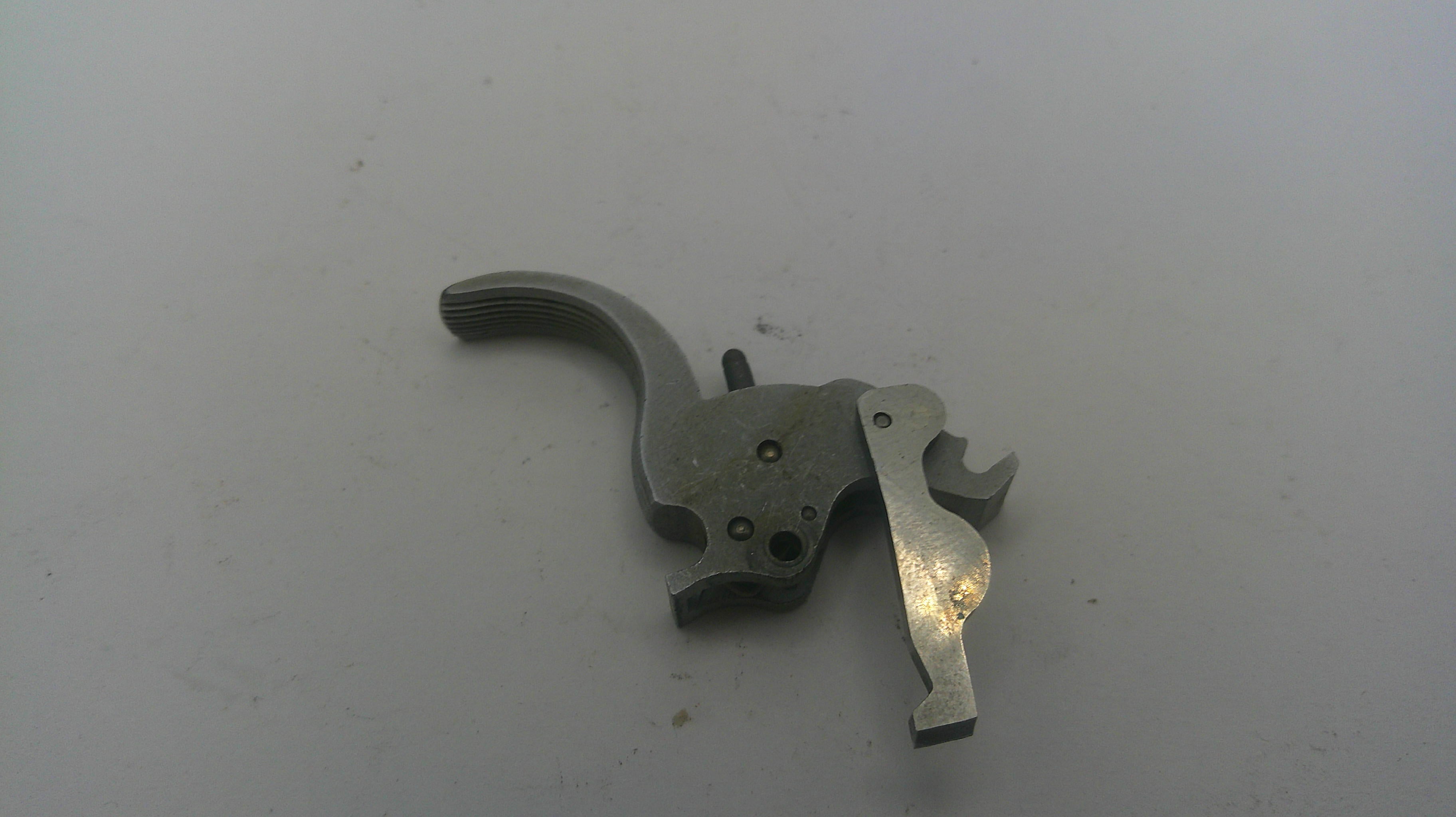 Metallic firearm part on a white background