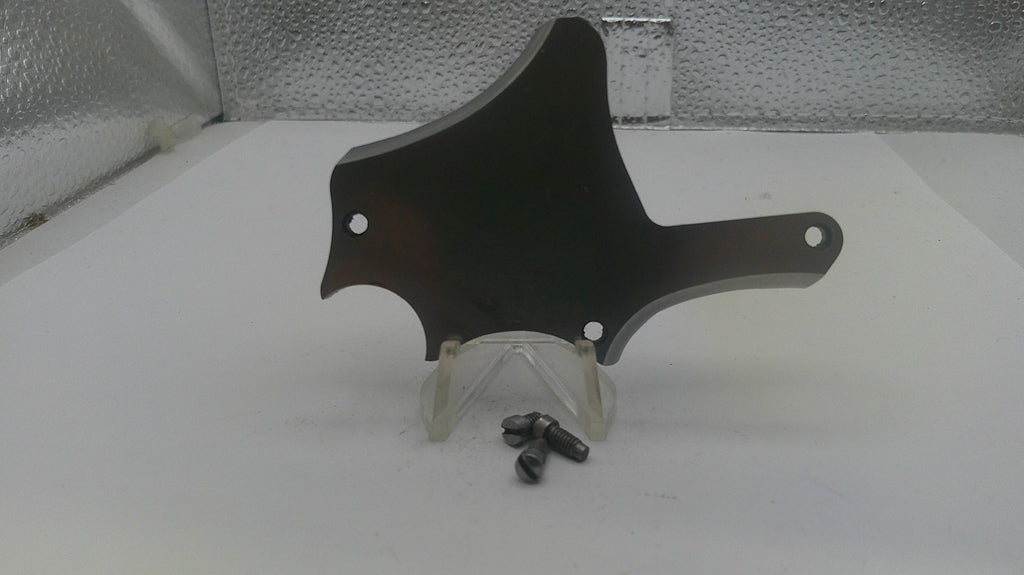 Black motorcycle part on a stand with screws on a white surface