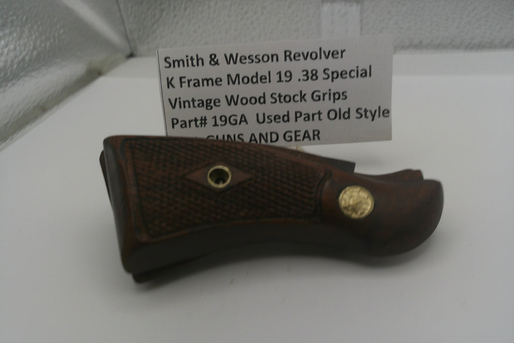 Vintage Smith & Wesson revolver grip with a label on a white surface