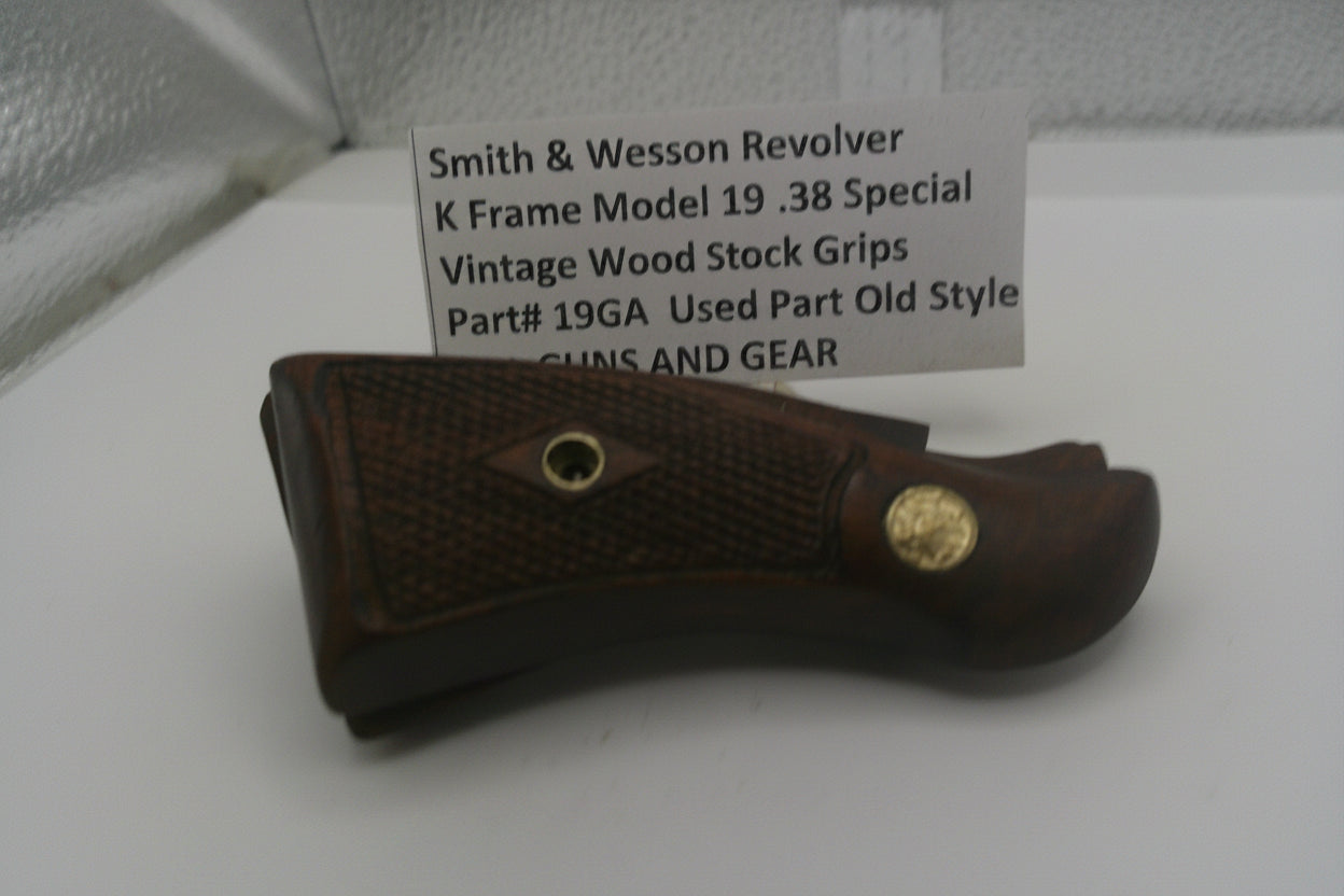Vintage Smith & Wesson revolver grip with a label on a white surface