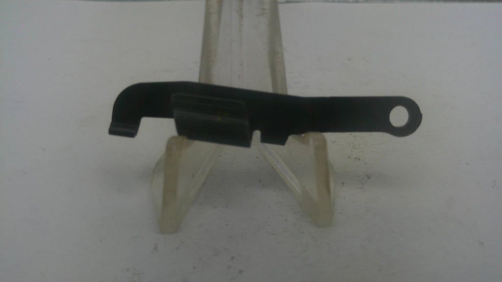 A small black plastic or metal tool component with a looped end, displayed on a clear plastic stand against a plain light background.