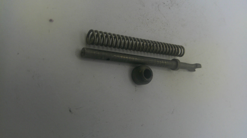 Two metal springs and a cylindrical component on a white surface
