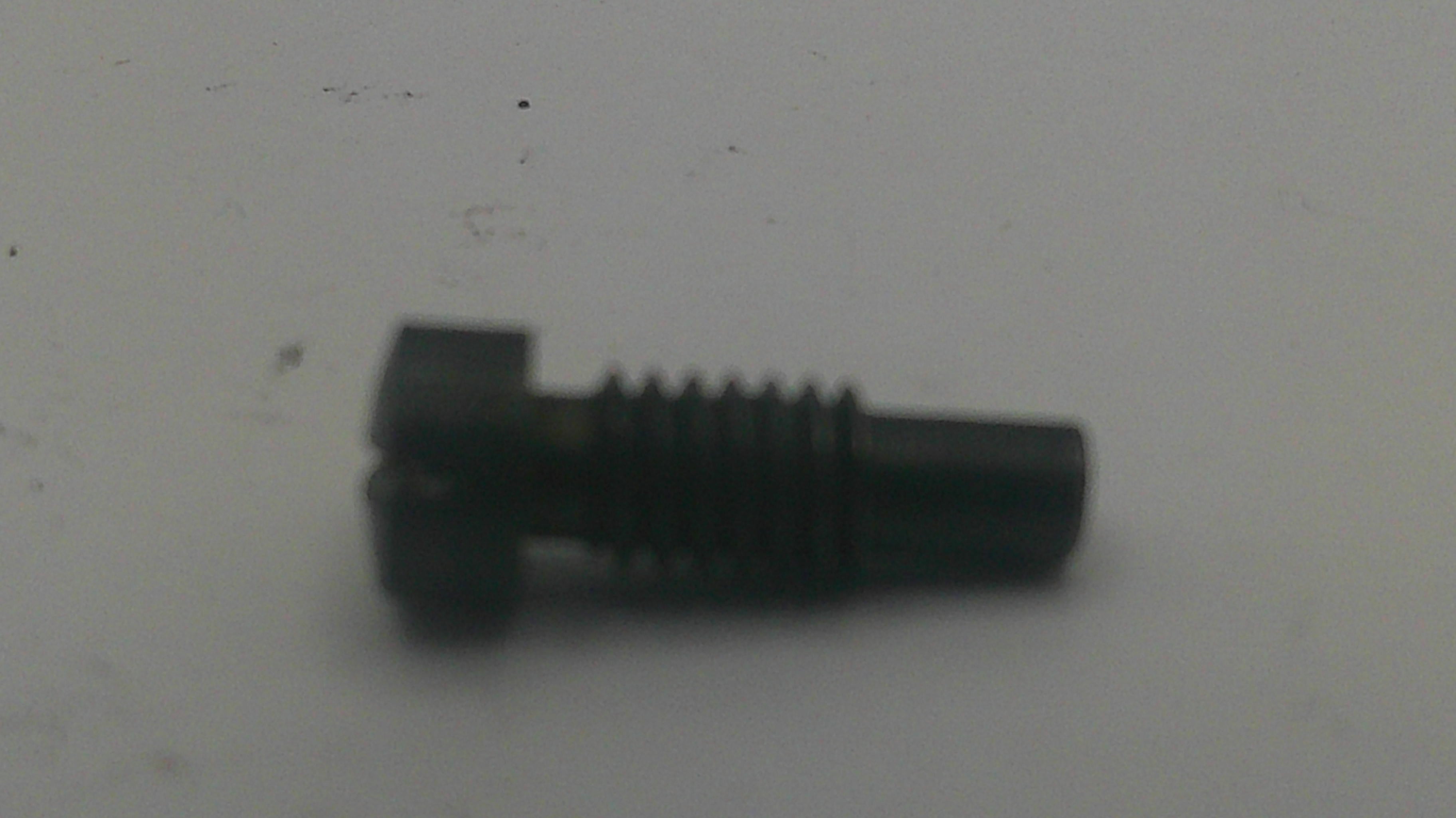 A small black metal threaded screw or bolt with a square head, shown on a plain light gray surface.