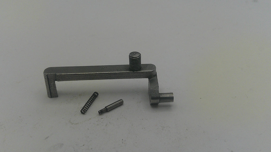 Metal tool with two small components on a light gray background