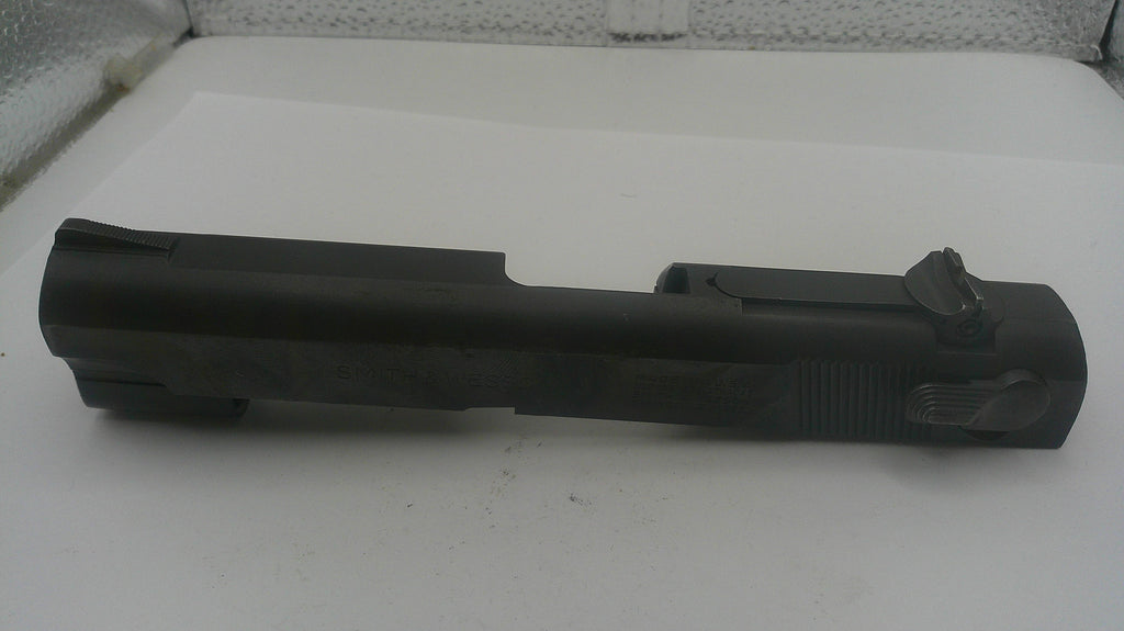 Black gun slide on a white surface