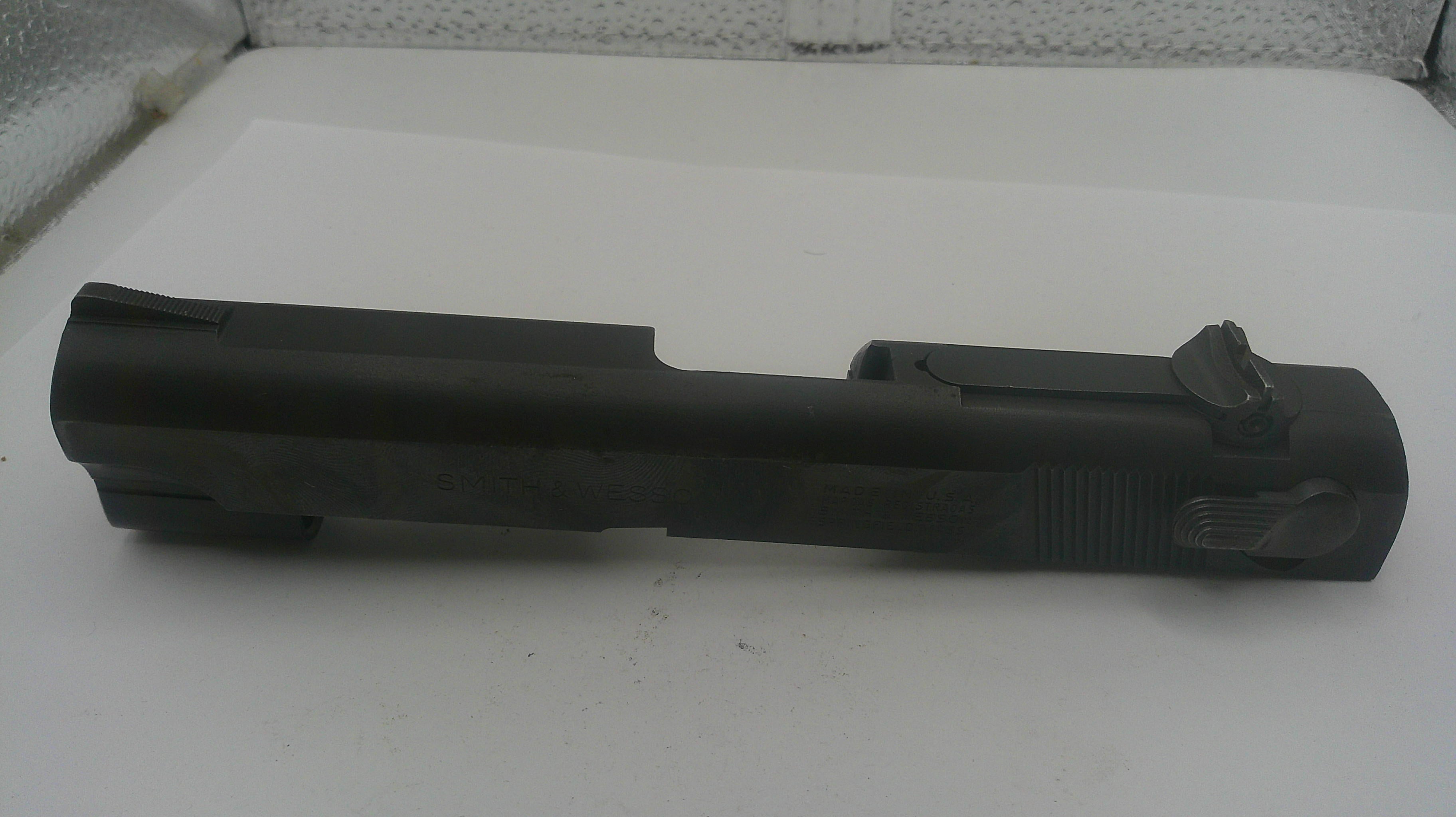 Black gun slide on a white surface