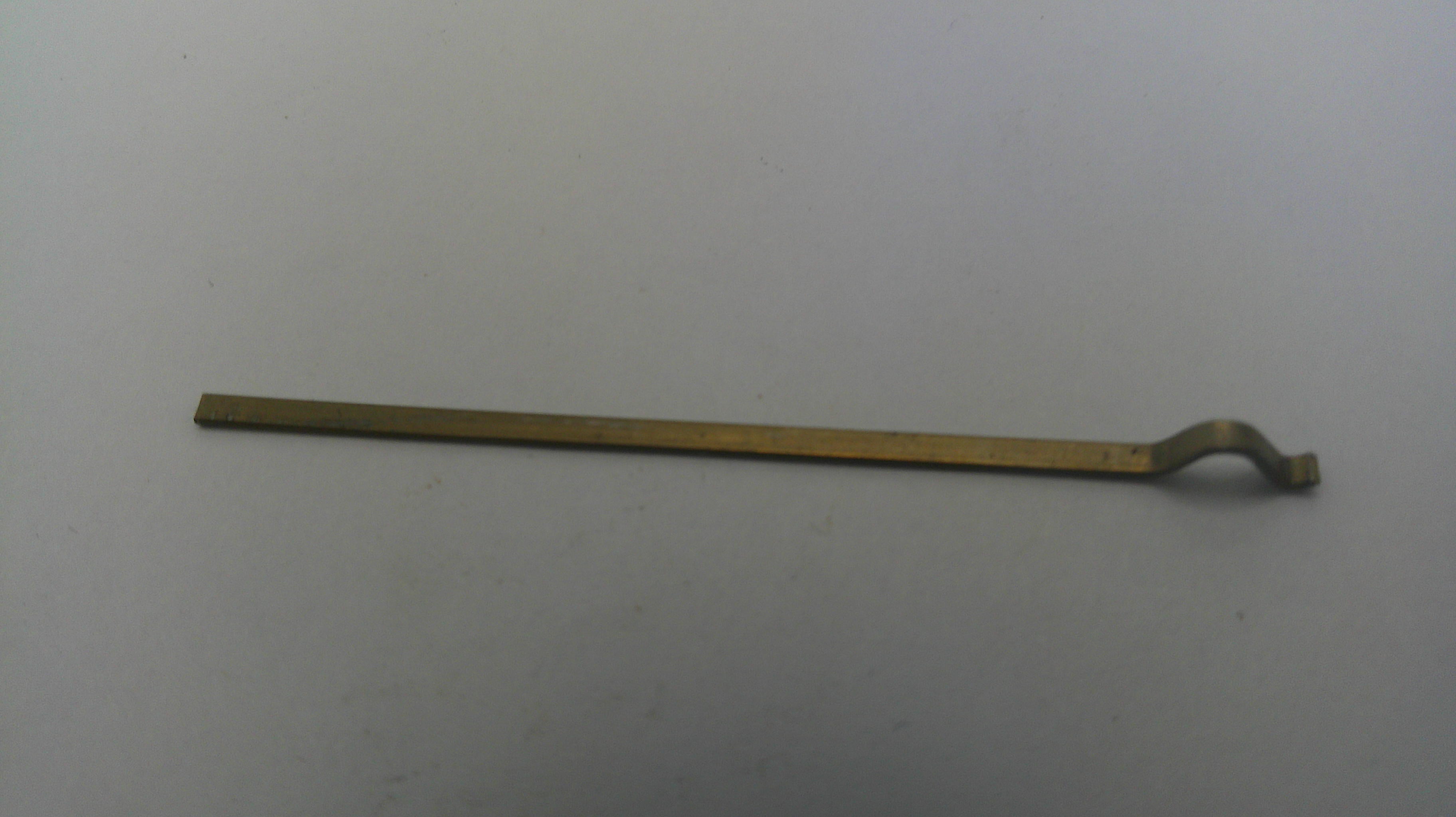 Long, thin metal tool on a white background