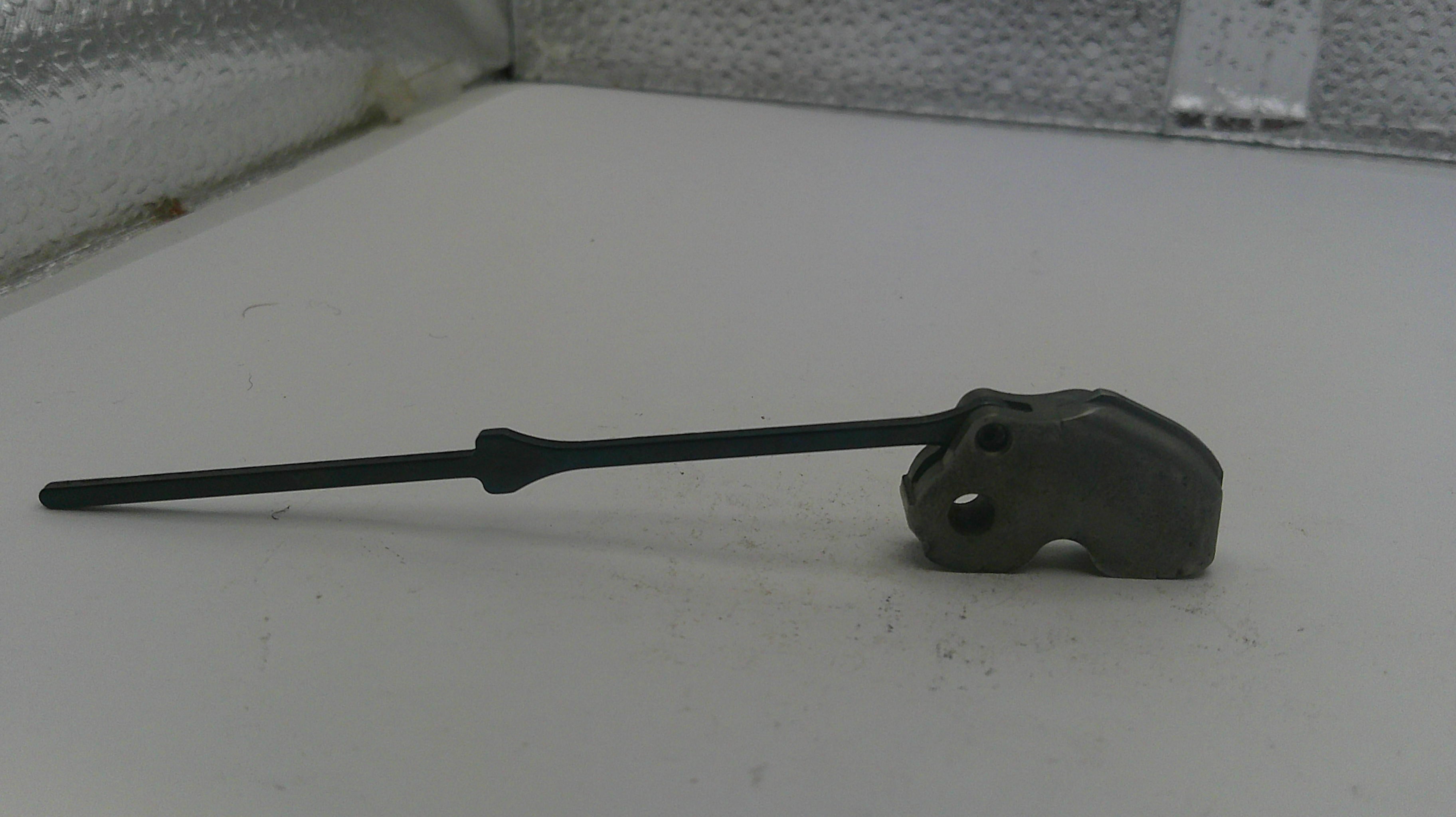 Black wiper blade on a white surface with a textured background