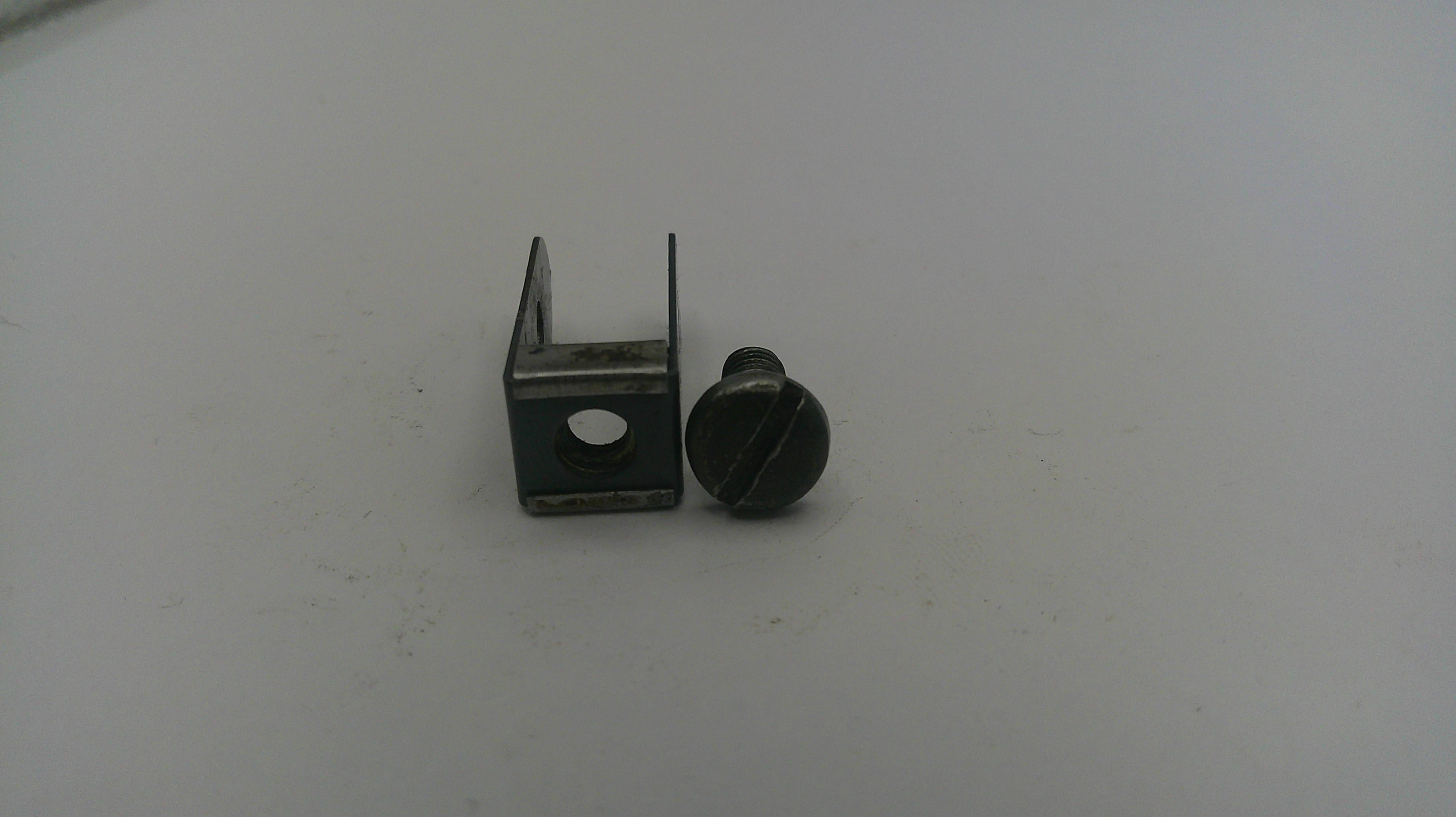 Small metal bracket and screw on a white background