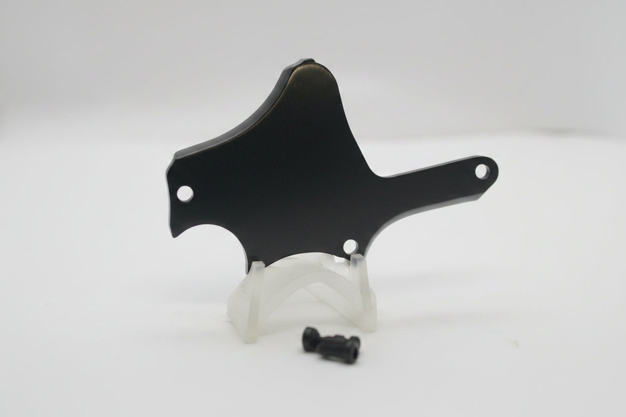 A black metal mounting bracket or shield with pre-drilled holes, shown on a plain white background.