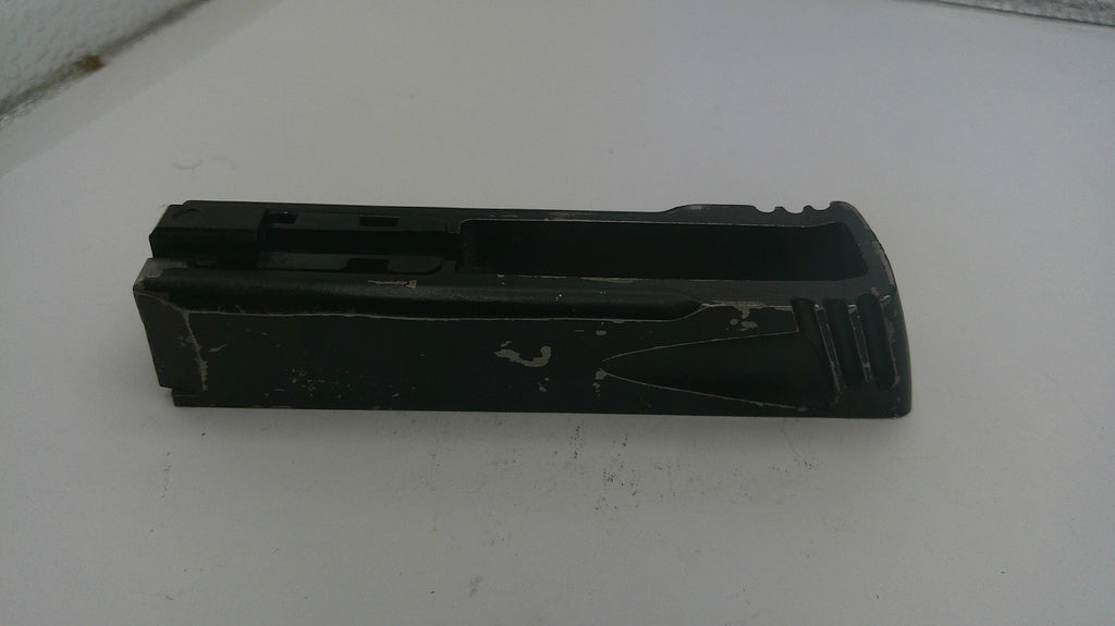 Black plastic component on a white surface