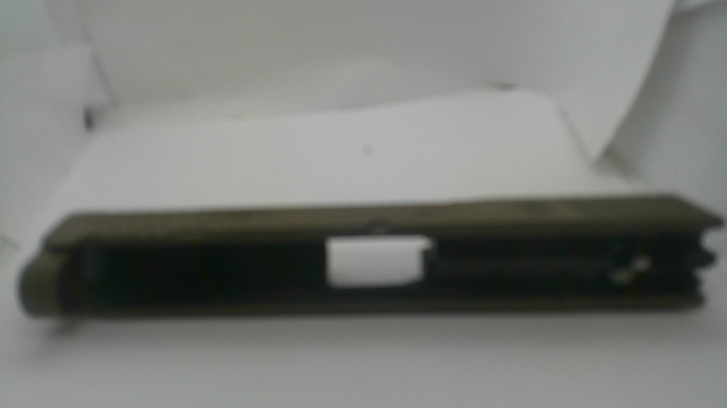 A dark olive green folding knife shown closed, resting horizontally on a white surface inside a white box.