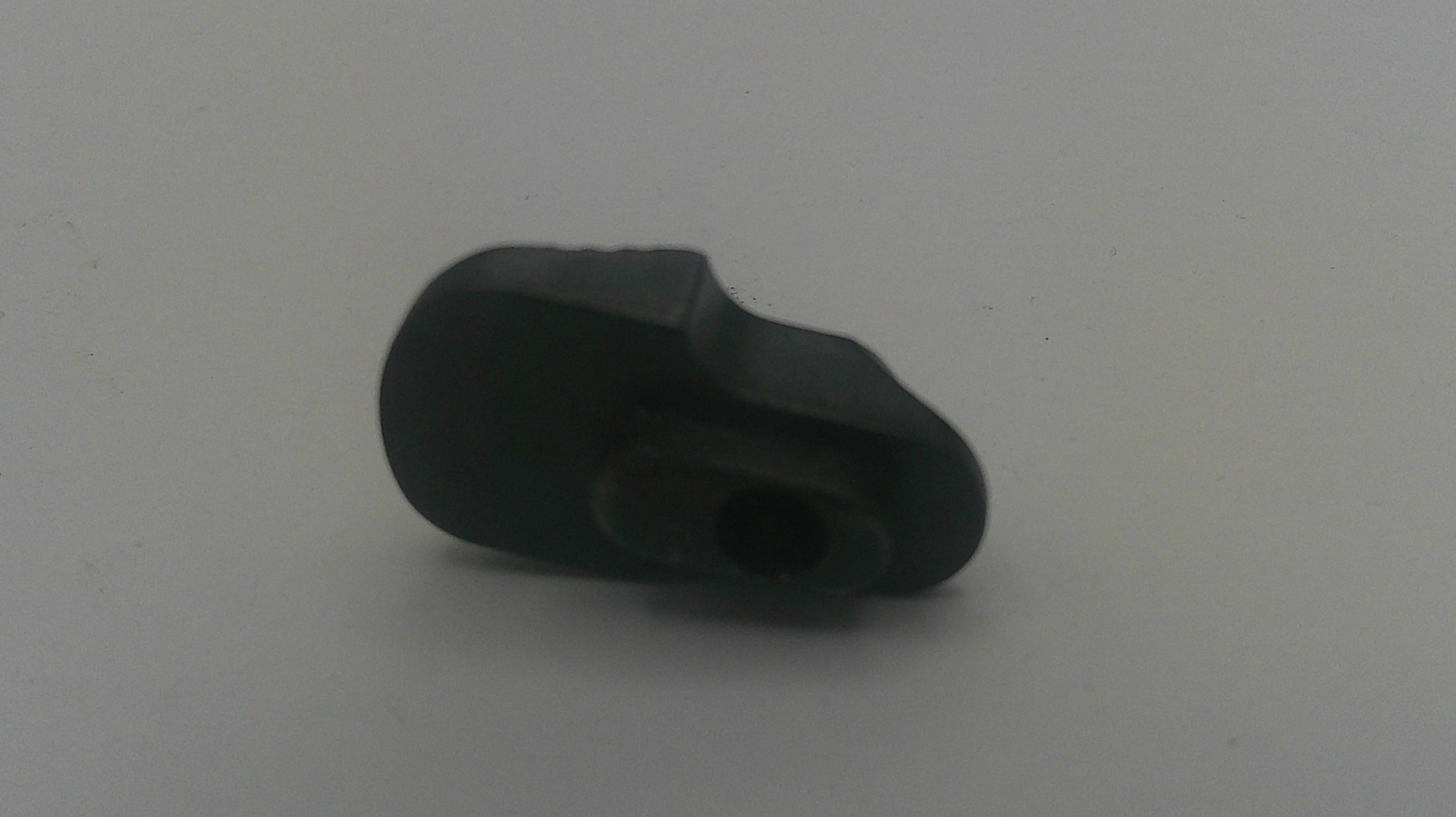 A small black plastic component or adapter with a central hole, photographed on a plain light gray background.