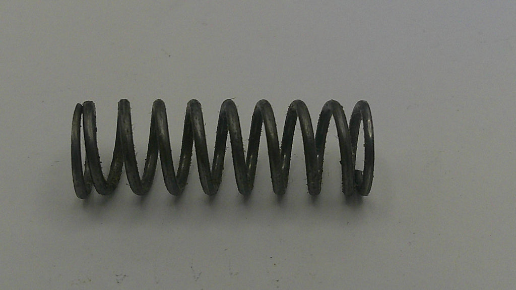 Coiled spring on a plain background