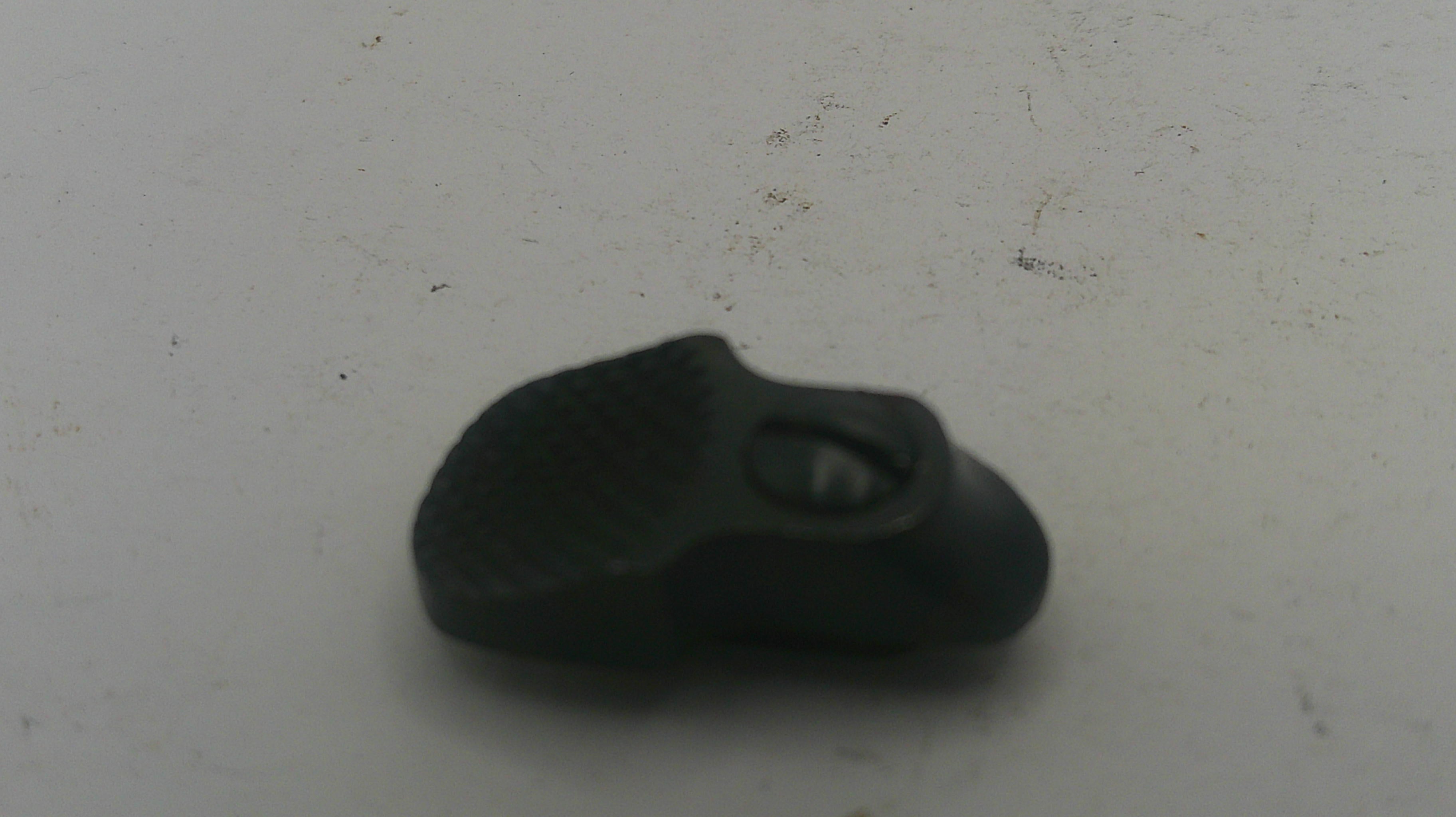 Black rubber band on a white surface