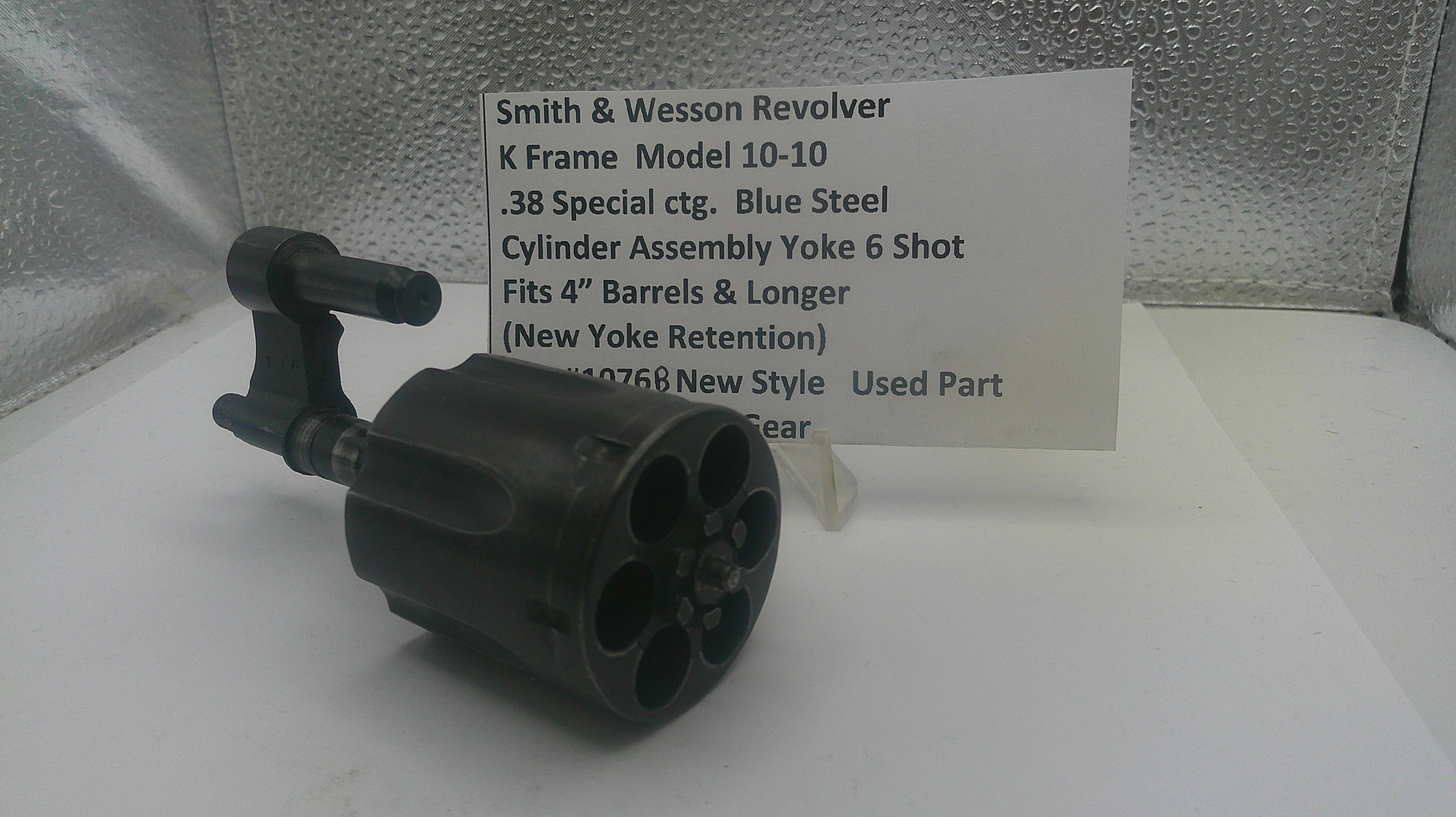 Smith & Wesson revolver cylinder assembly with a label on a reflective surface