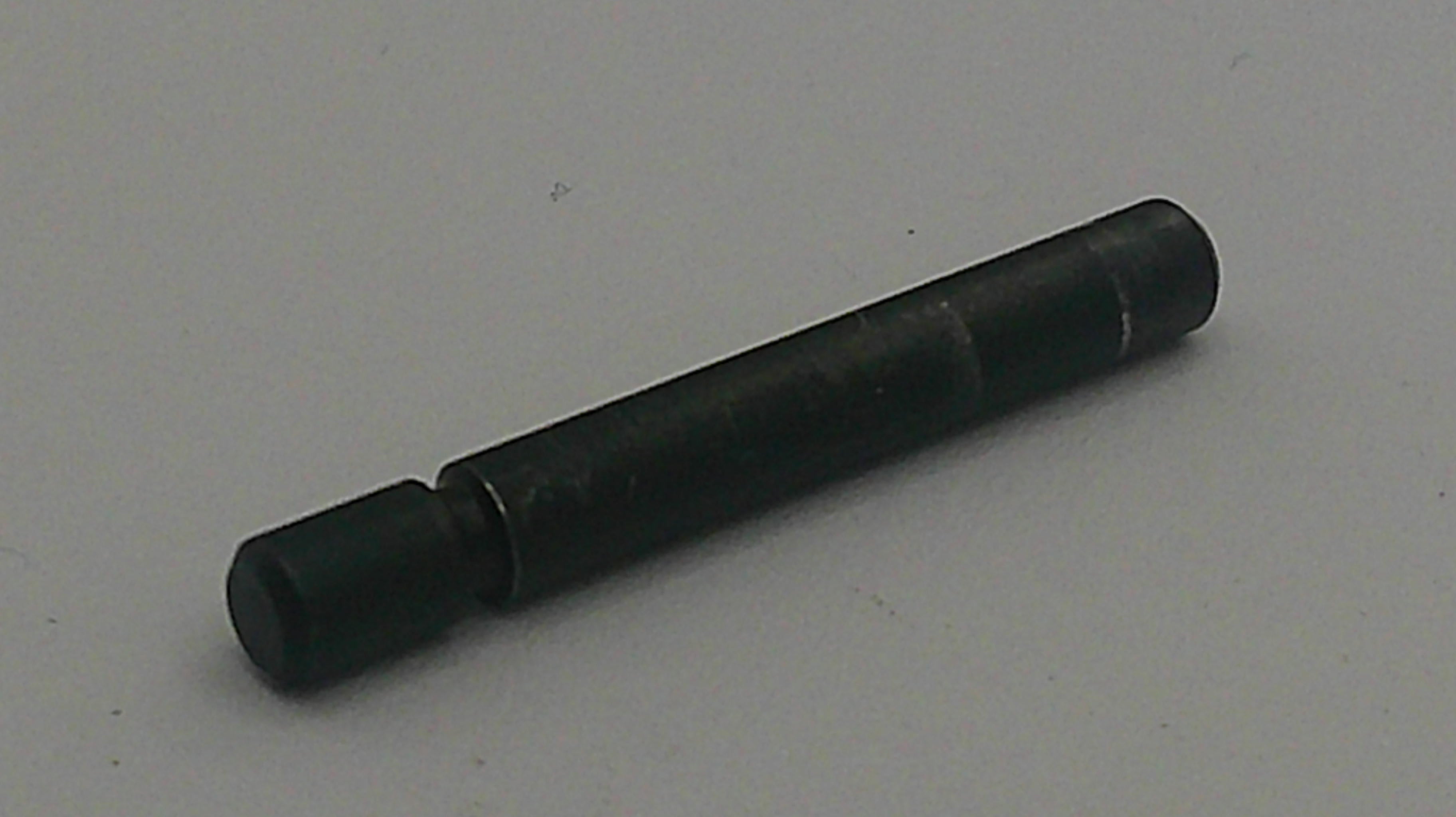 Black cylindrical object on a light gray background