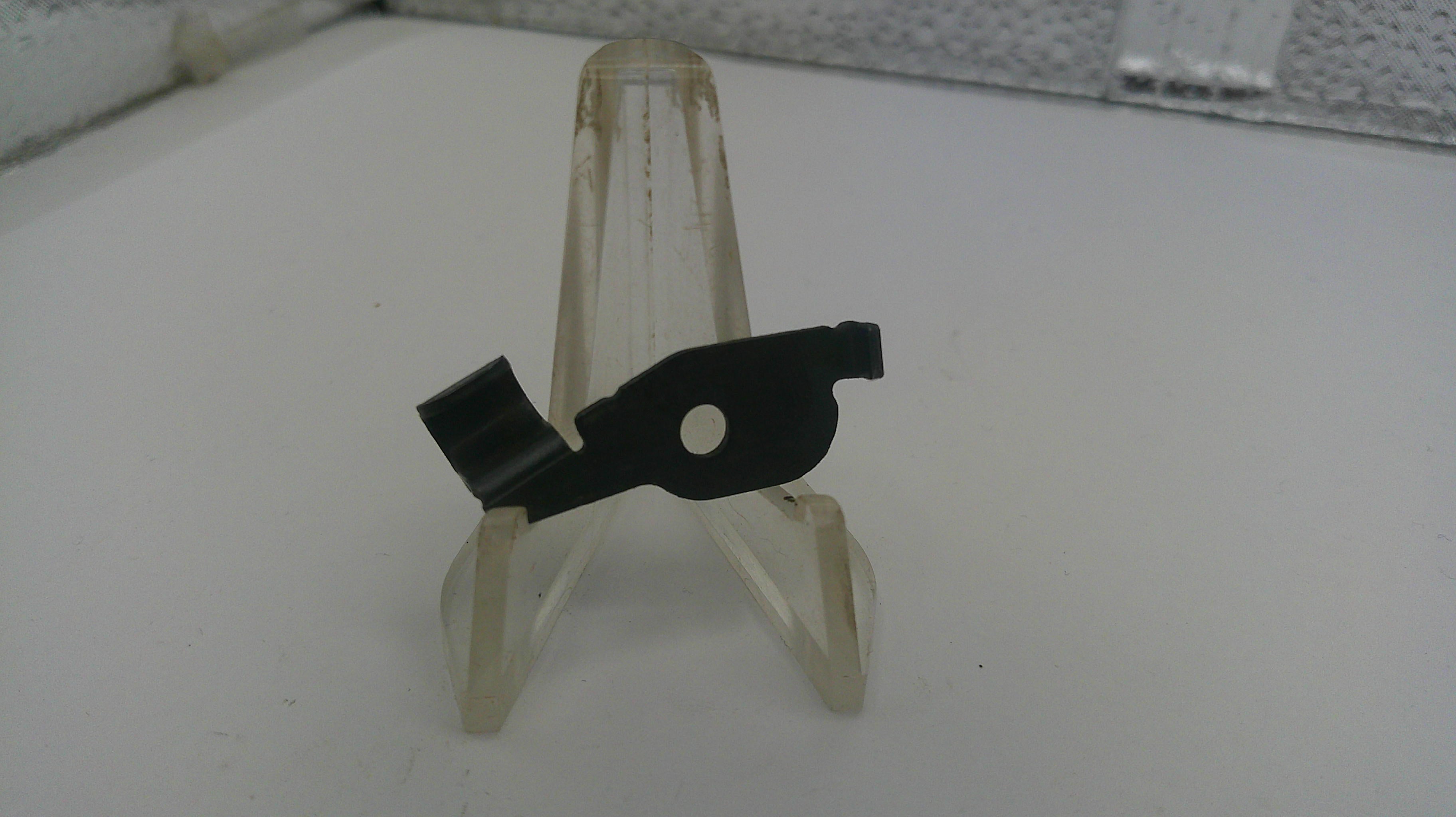 Small black and clear plastic stand on a white surface