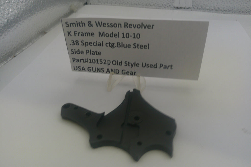 Smith & Wesson revolver side plate on a white background with a label.