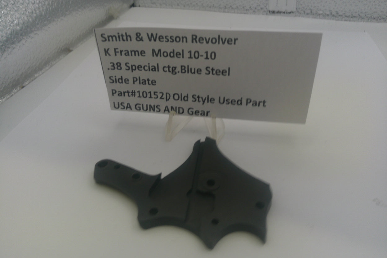 Smith & Wesson revolver side plate on a white background with a label.