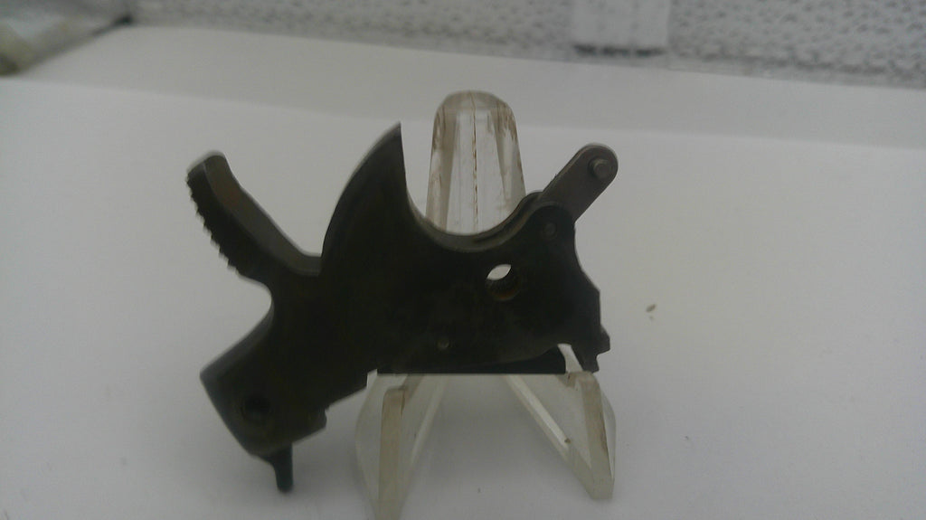 Black metal bracket on a white stand with a textured background