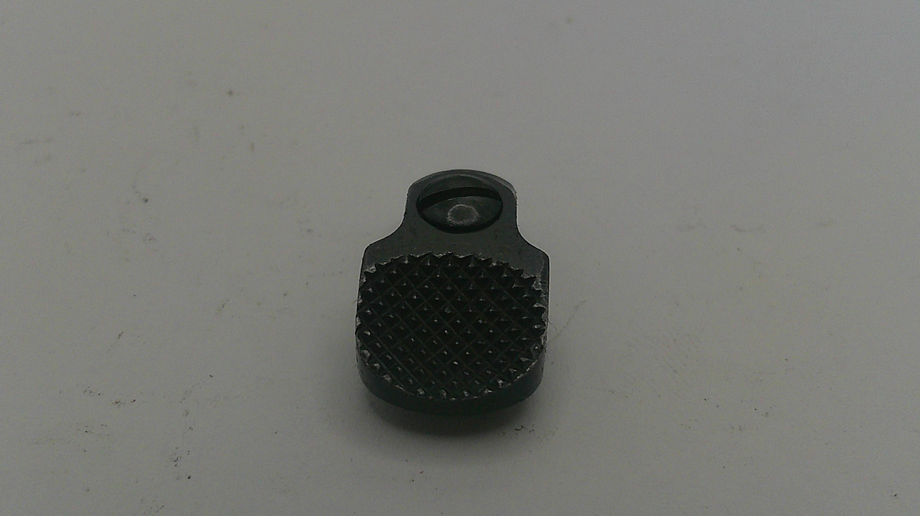 Black textured object on a light gray background