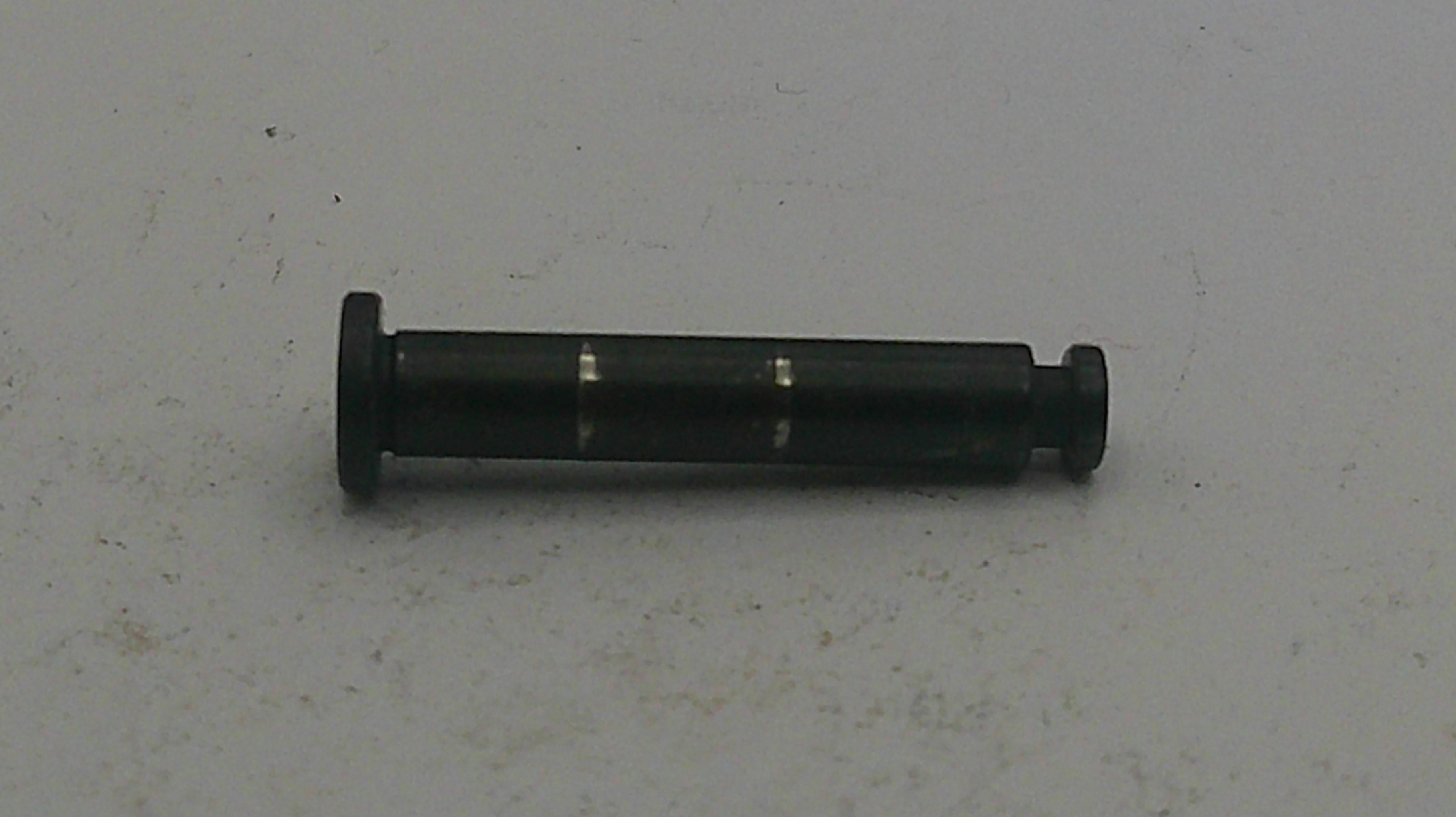 Black cylindrical object on a light gray background