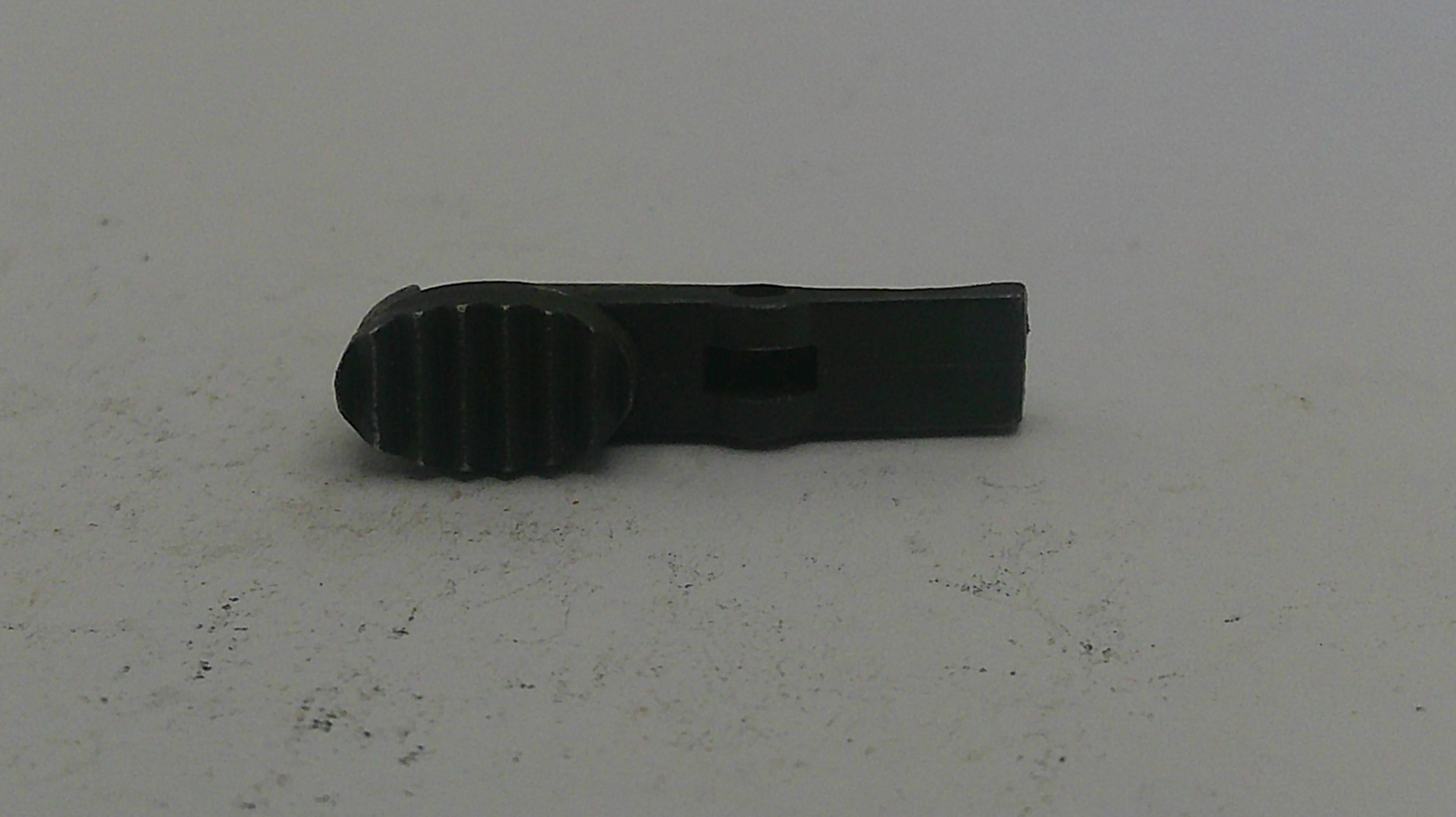 Black plastic component on a white background