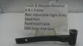 A used black metal part for a Smith & Wesson revolver rear adjustable sight body, displayed on a clear stand with a white label card showing part details.
