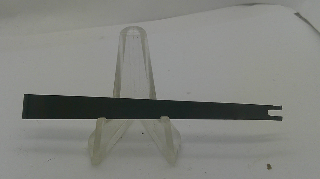A long, thin black metal tool with a forked end, displayed horizontally on a clear plastic stand against a plain white background.