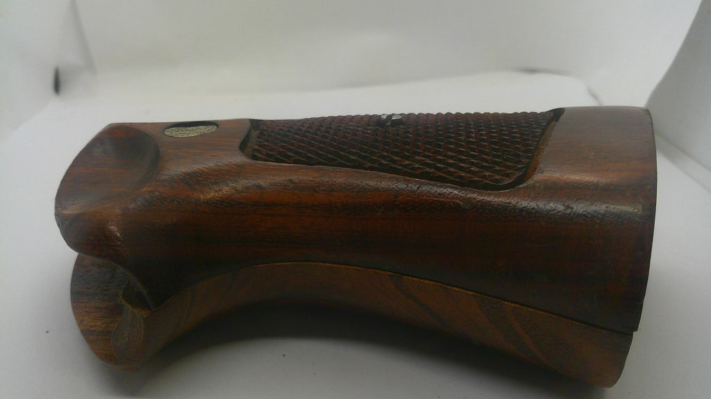 A wooden gun stock grip with a textured grip panel, shown on a plain white background.
