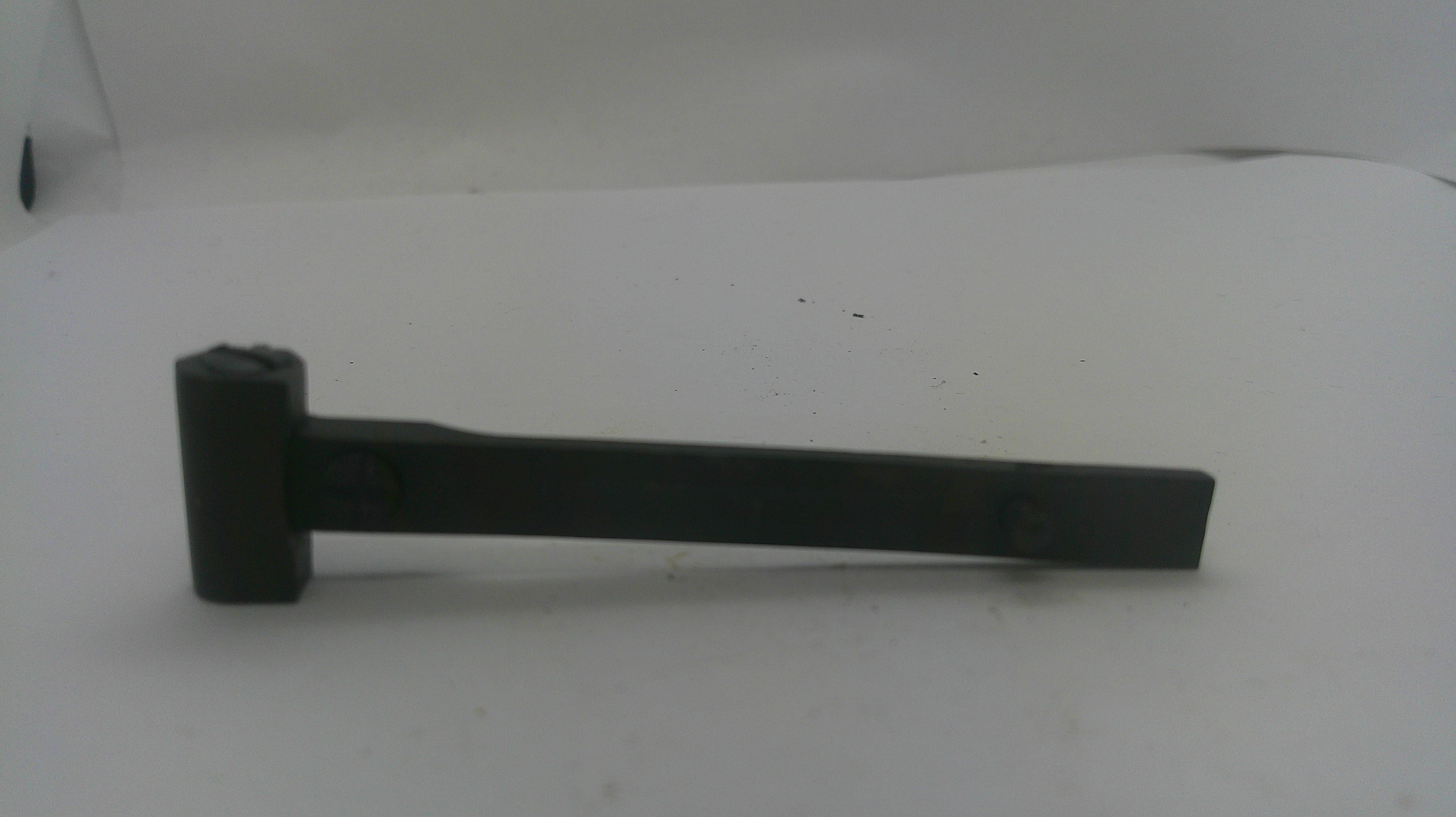 A black metal tool with a flat rectangular head and a long arm, photographed on a plain white surface.