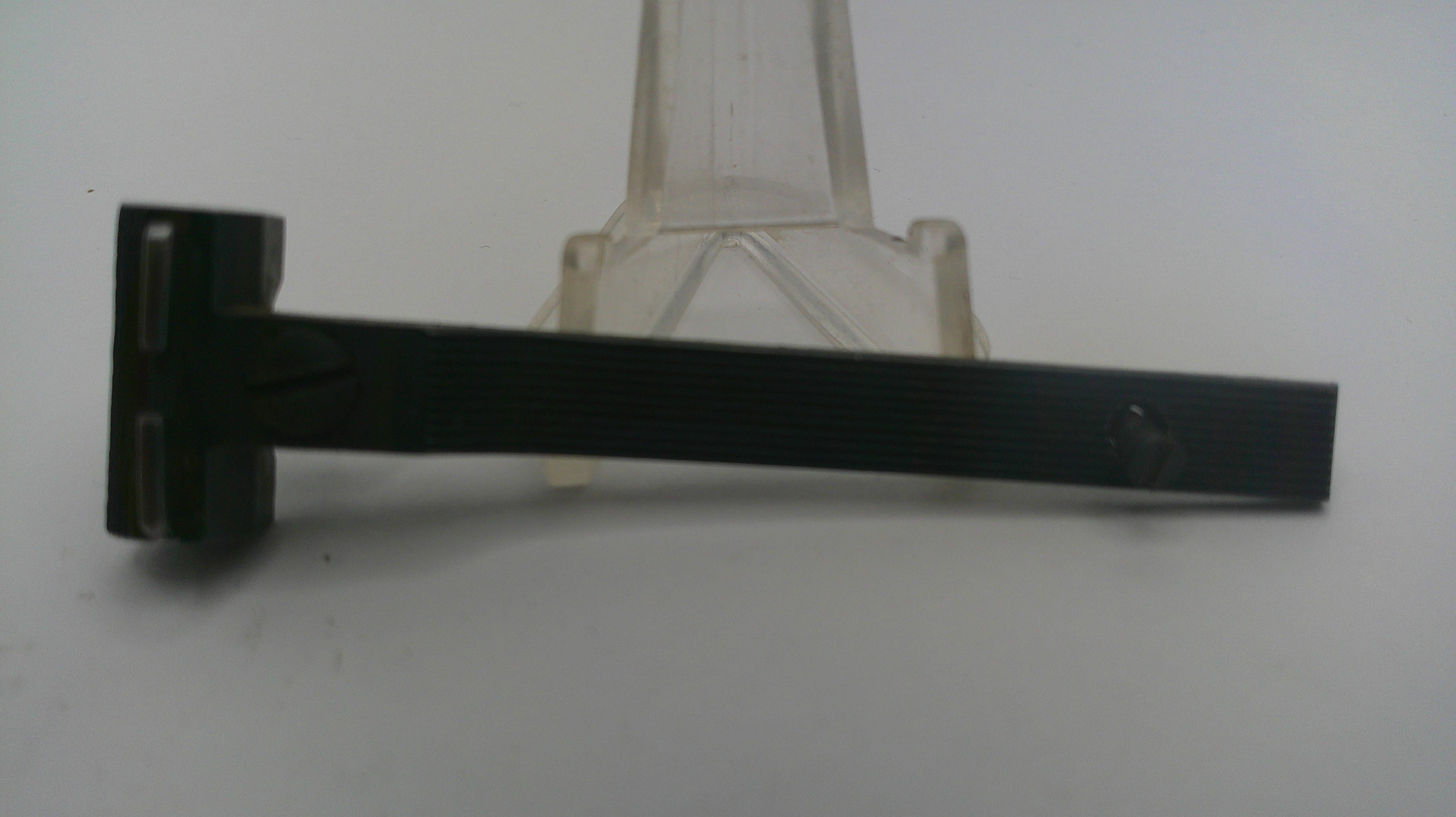 Black metal T-shaped tool on a white background