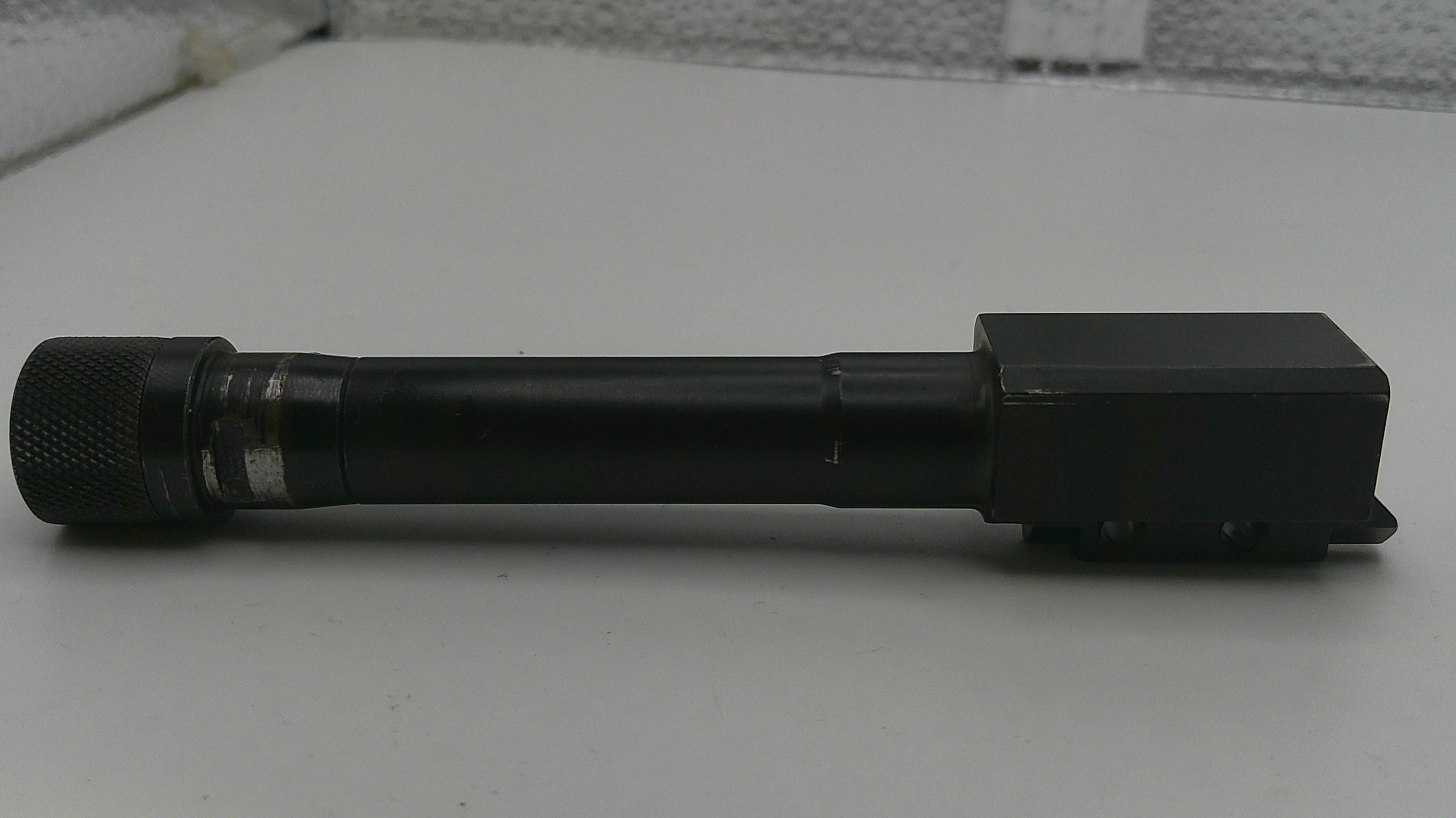 Black cylindrical tool on a white surface
