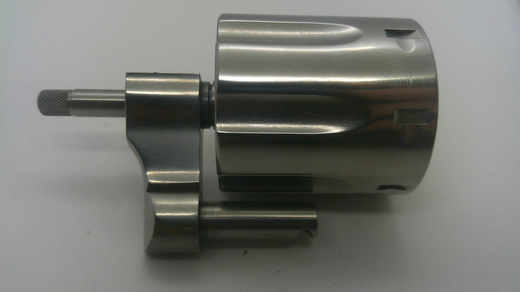 A machined metallic cylindrical component with a short shaft and mounting bracket, photographed on a plain light background.