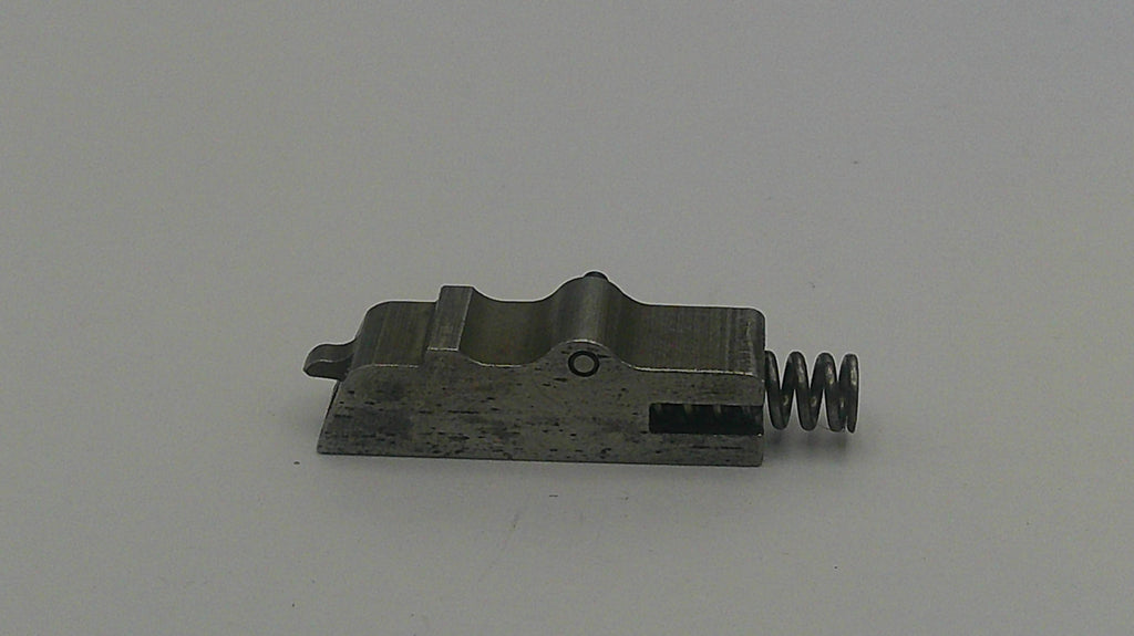Metal component with a spring on a gray background
