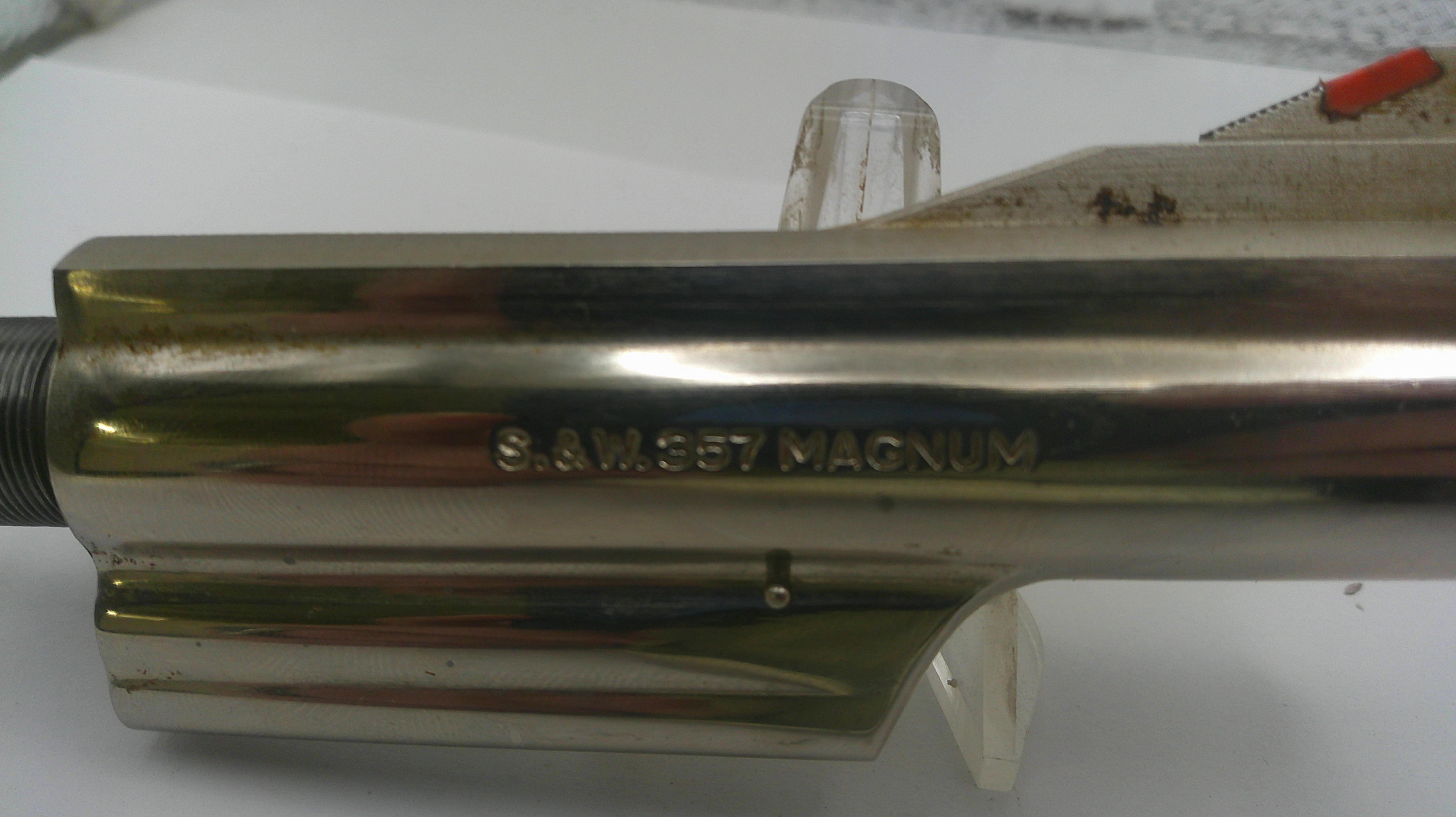 Metallic cylindrical object with 'S&W 357 Magnum' engraving on a white background