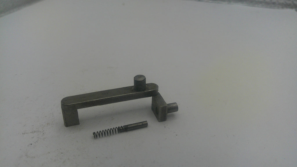 Metal lever and screw on a white surface
