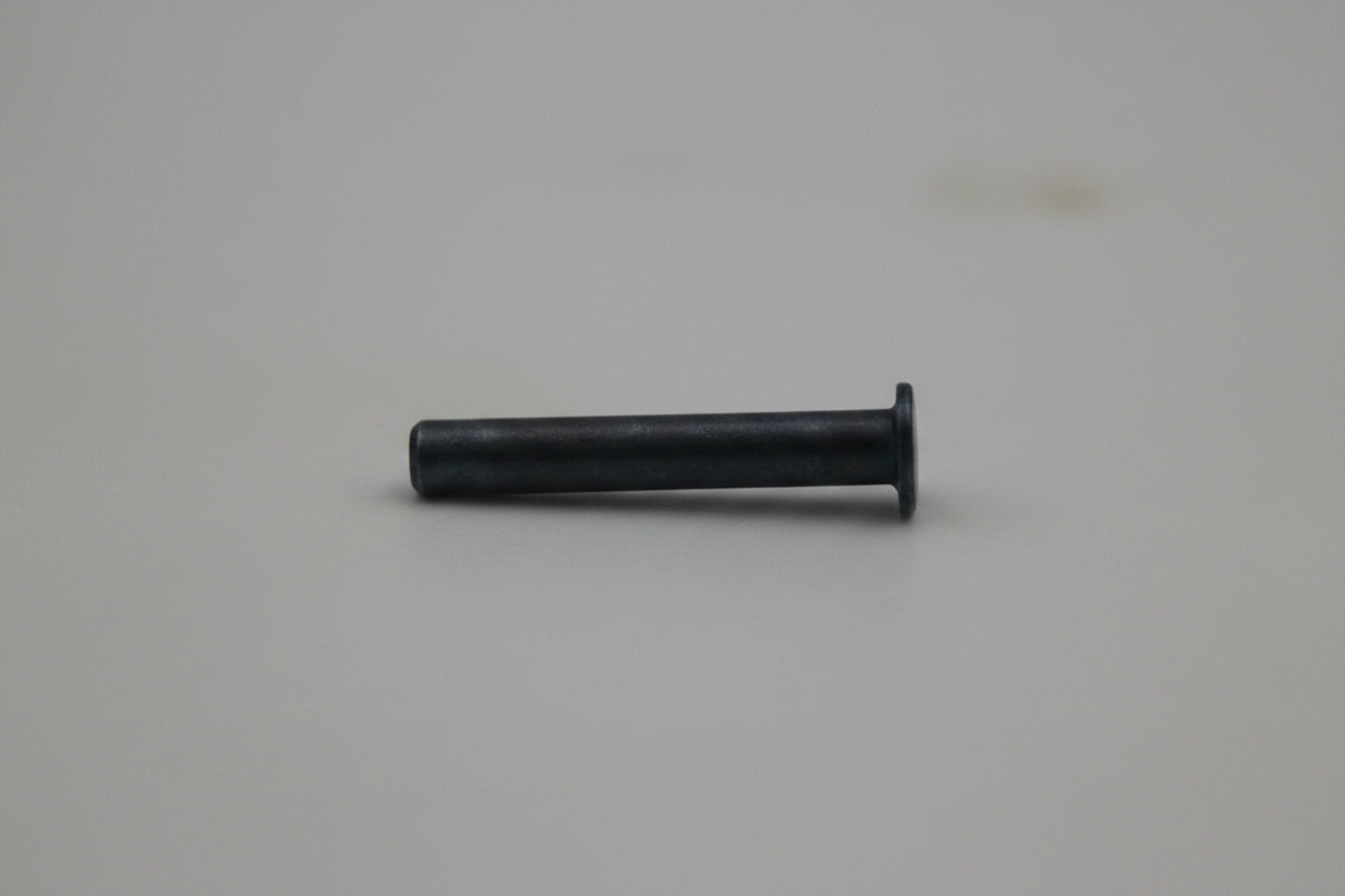 A small dark metal pin or bolt with a flat head, shown horizontally against a plain light gray background.